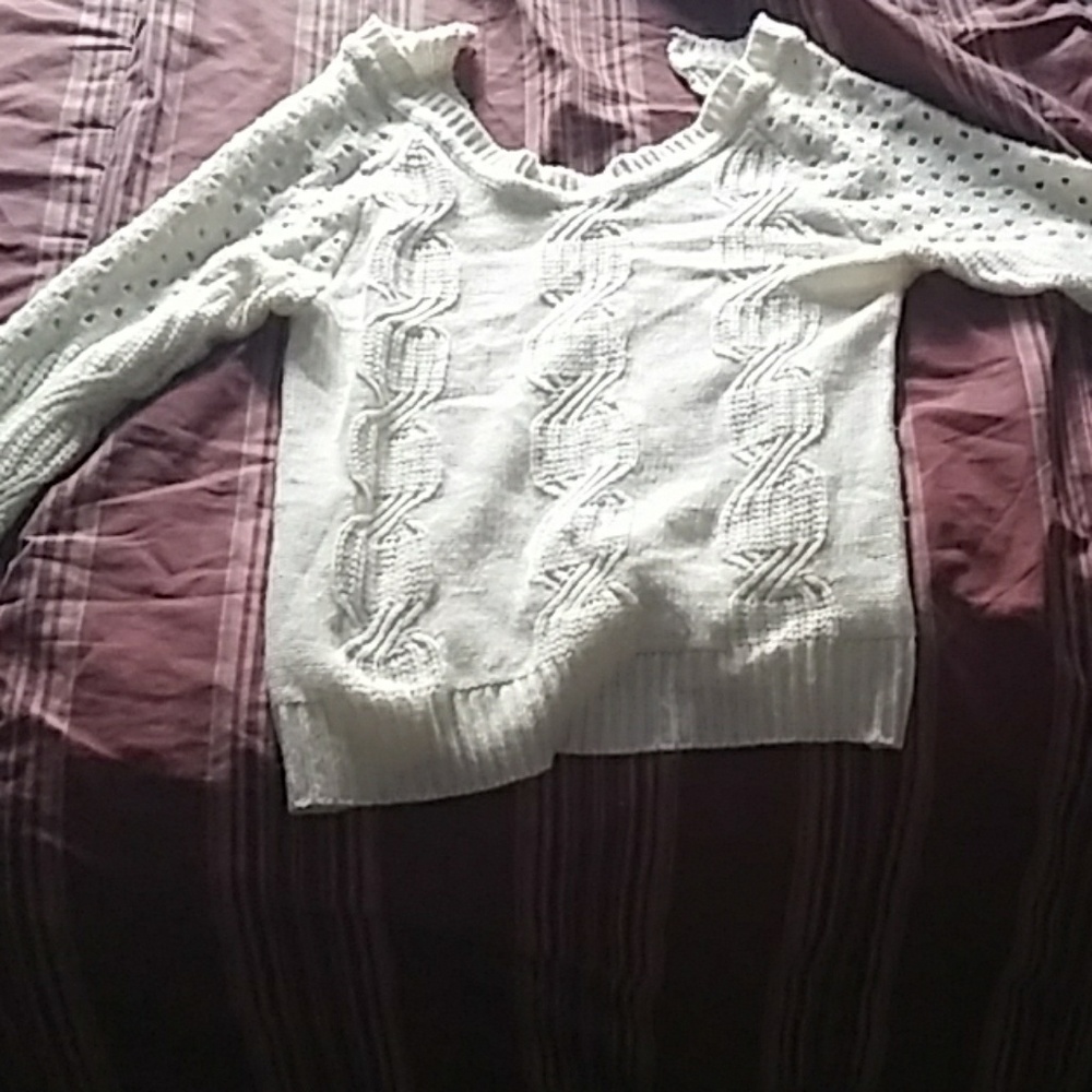 A long sleeve white sweater